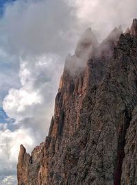 Low angle view of rocky mountains against sky