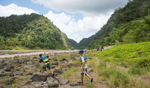 Panoramic view of people on landscape against sky