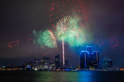 Low angle view of firework display at night