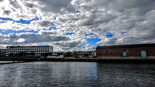 Buildings against cloudy sky