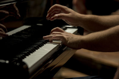 Close-up of man playing piano