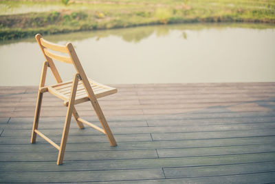 Wooden table by lake