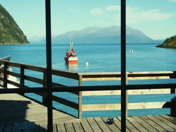 Scenic view of sea with mountain range in background