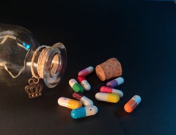 Close-up of candles on table against black background