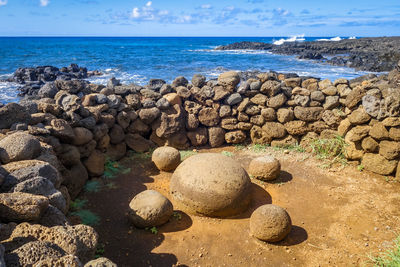 Rocks on beach against sky