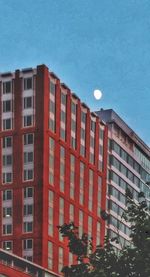 Low angle view of buildings against blue sky