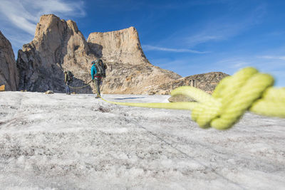 Detail of climbing rope attached to climbing team in the mountains.