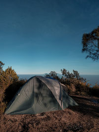 Tent on field against sky