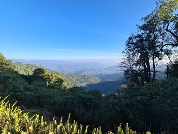 Scenic view of mountains against blue sky