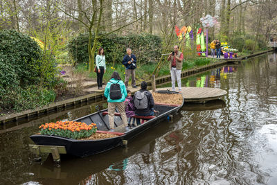 People in boat against river