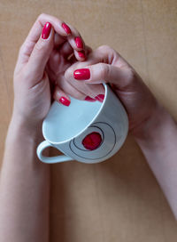 Close-up of woman holding red hand