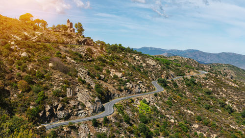 High angle view of road amidst trees against sky