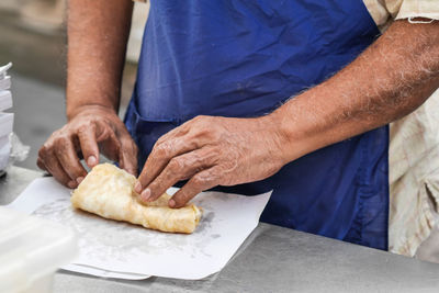 Midsection of man preparing food