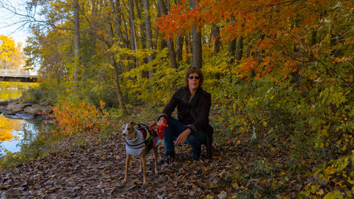 Portrait of woman with dog in autumn