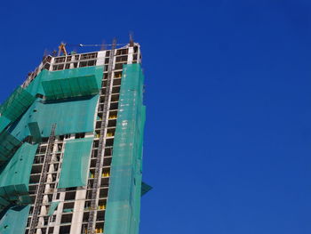 Low angle view of built structure against blue sky