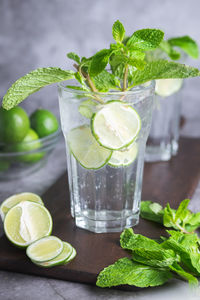 Close-up of mojito in glass with ingredients on table