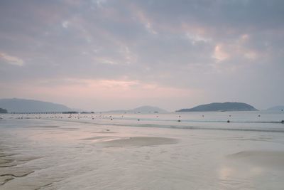 Scenic view of beach against sky during sunset