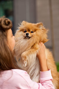 Portrait of woman with dog at home