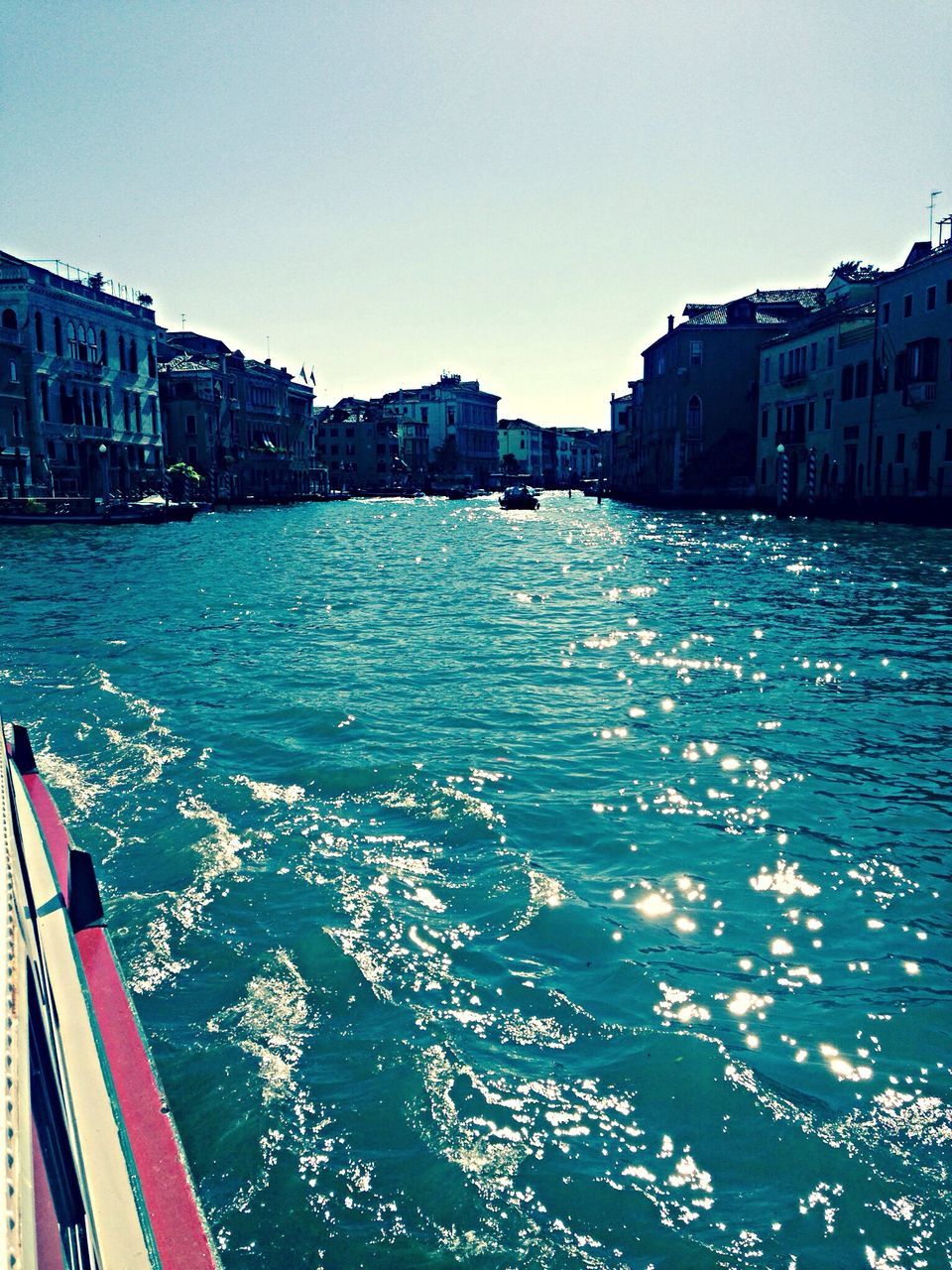 building exterior, architecture, water, built structure, waterfront, transportation, city, nautical vessel, clear sky, canal, mode of transport, blue, boat, sea, river, rippled, building, travel, residential building, residential structure