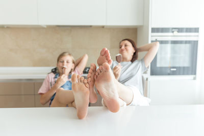 Young woman using mobile phone at home