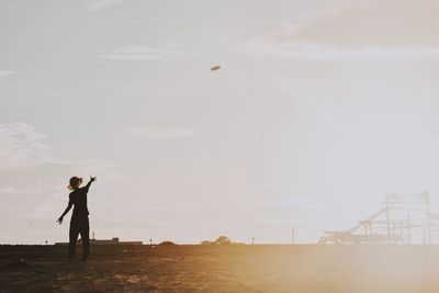 Man standing on field against sky