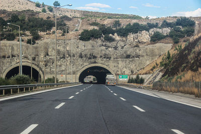 Road leading towards mountain against sky