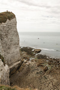 Rock formation on beach against sky