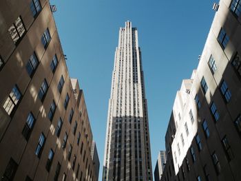 Low angle view of skyscrapers against clear blue sky