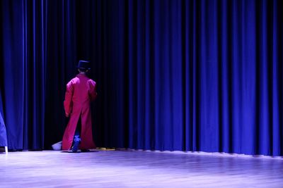 Rear view of man standing on stage