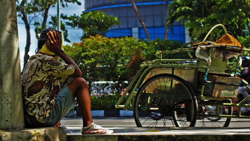 Man sitting by statue