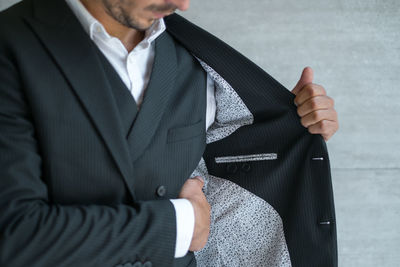 Man looking at his inner pocket on his suit. high quality photo