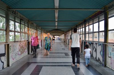 Rear view of people walking in corridor