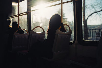 Silhouette of man sitting in train