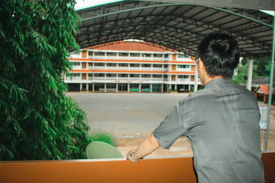 Rear view of man standing on railway station