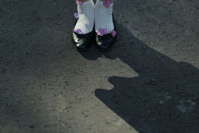 Low section of woman standing on street