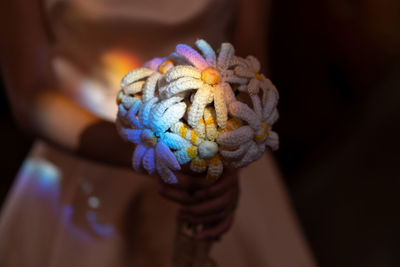 Close-up of hand holding multi colored candies