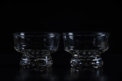 Close-up of glass bowls against black background