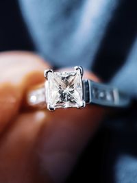 Close-up of human hand holding diamond ring