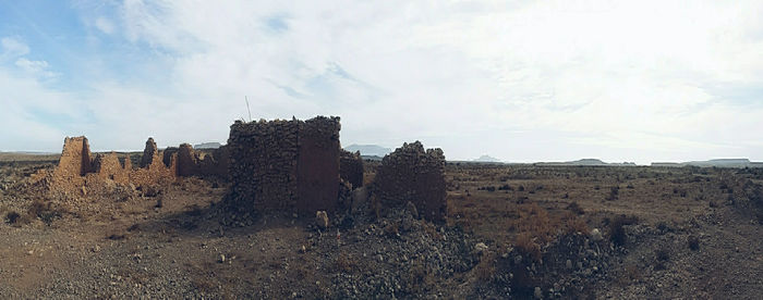 Rock formations on landscape against sky