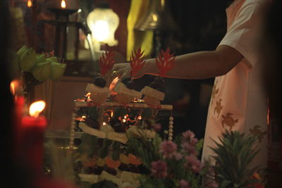 Panoramic view of lit candles in temple