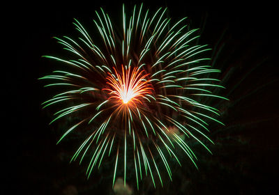 Low angle view of firework display at night