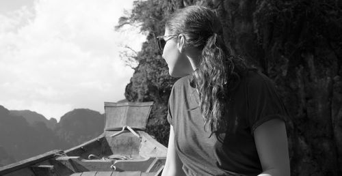 Woman standing in front of mountain against sky