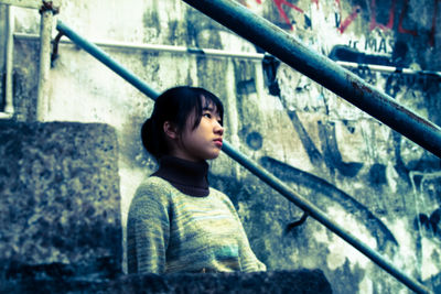 Full length of young woman holding camera