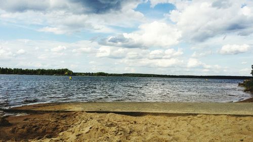 View of calm lake against cloudy sky