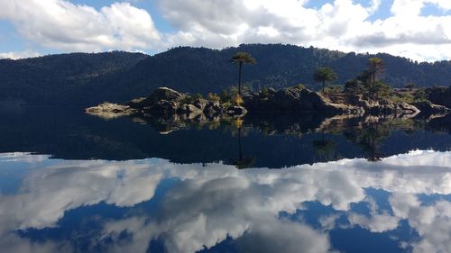 Scenic view of lake and mountains against sky