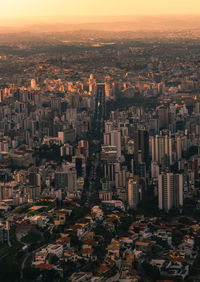 High angle view of city buildings against sky during sunset