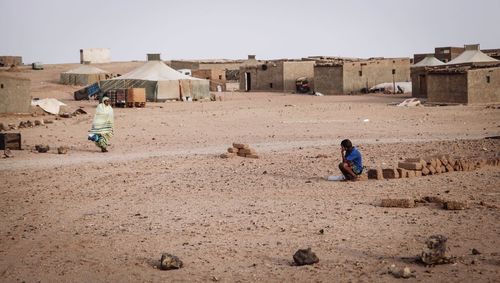 Woman in desert against clear sky