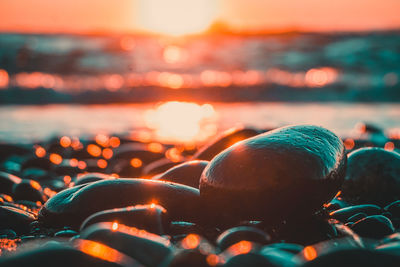 Close-up of illuminated lights in sea against sky at night