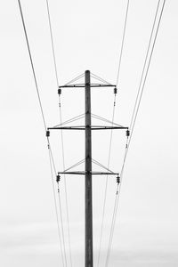 Low angle view of electricity pylon against sky