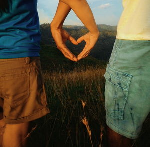 Rear view of couple holding hands